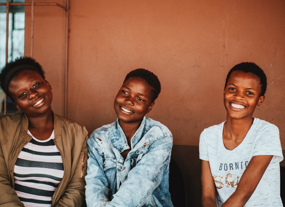 Three young women smiling together