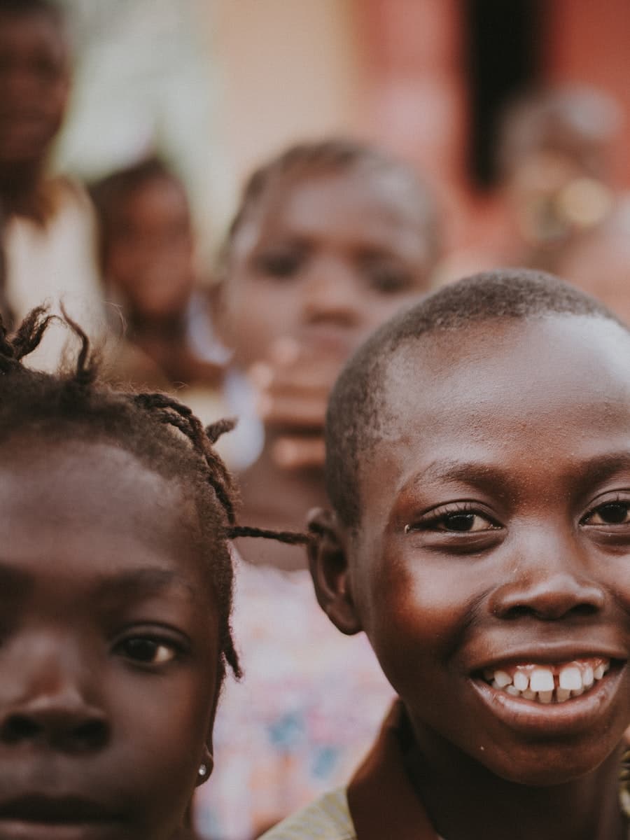 A smiling boy surrounded by other children