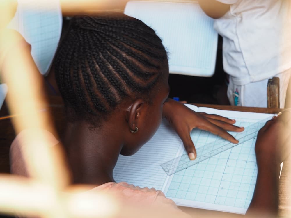A student working through her exercise book